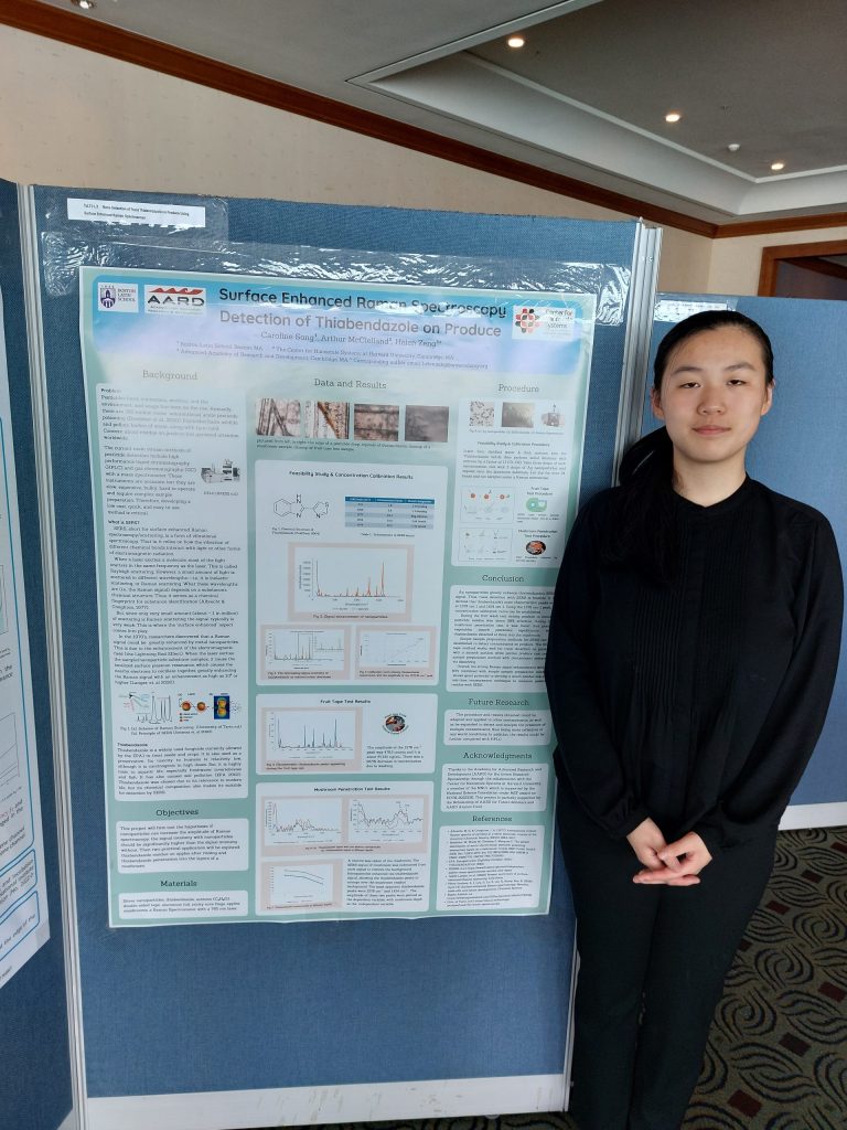 Caroline Song standing next to a poster presenting research
