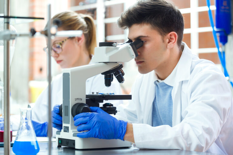 Portrait,Of,Young,Scientists,Carrying,Out,An,Experiment,In,A